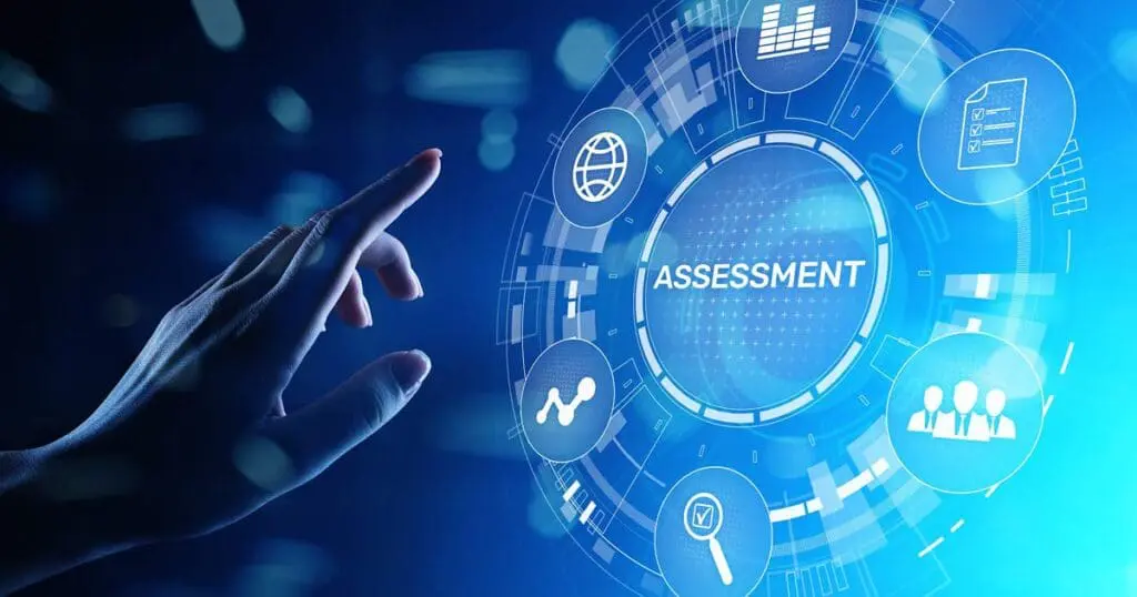 A hand reaches toward a digital interface displaying the word ASSESSMENT in the center, surrounded by icons representing data, graphs, analytics, and people, all on a blue, high-tech background.
