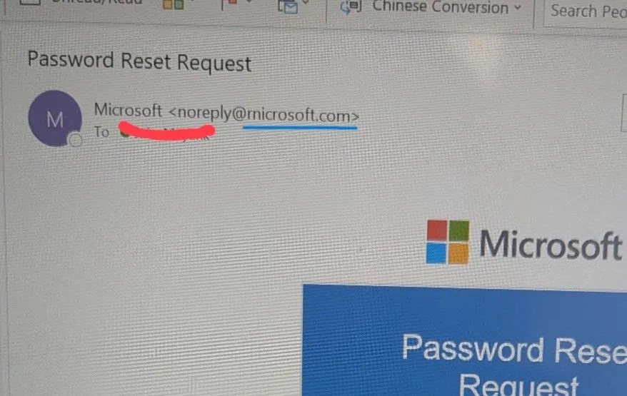 A computer screen displays an email titled Password Reset Request from Microsoft . Part of the recipients email address is redacted with a red line.