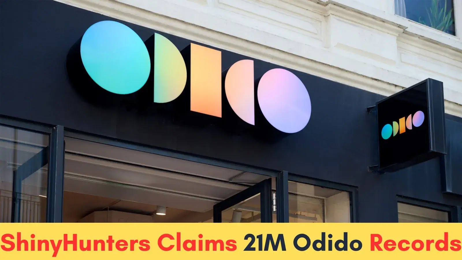A storefront sign with colorful geometric shapes and the text “Odido.” A headline below reads, “ShinyHunters Claims 21M Odido Records” in yellow and pink text on a yellow banner.