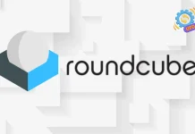 The image shows the Roundcube logo with a geometric cube and sphere design on the left and the word roundcube in lowercase black letters on the right. A small gear and ribbon icon is in the top right corner.