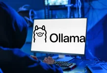 A person wearing a dark hoodie sits at a desk typing on a keyboard in front of a computer screen displaying the Ollama logo in a dimly lit room with cables and monitors in the background.
