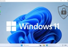 Windows 11 desktop with a blue abstract background, Windows 11 logo and text in the center, and a security padlock shield icon in the upper right corner.