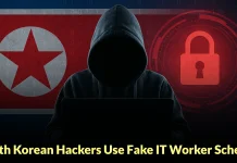 A hooded figure using a laptop is shown in front of a North Korean flag and a red padlock graphic, with the text North Korean Hackers Use Fake IT Worker Sche... at the bottom.