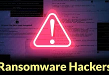 A glowing warning sign with an exclamation mark is overlaid on a background of blurred computer code. The text Ransomware Hackers appears at the bottom in bold yellow letters.