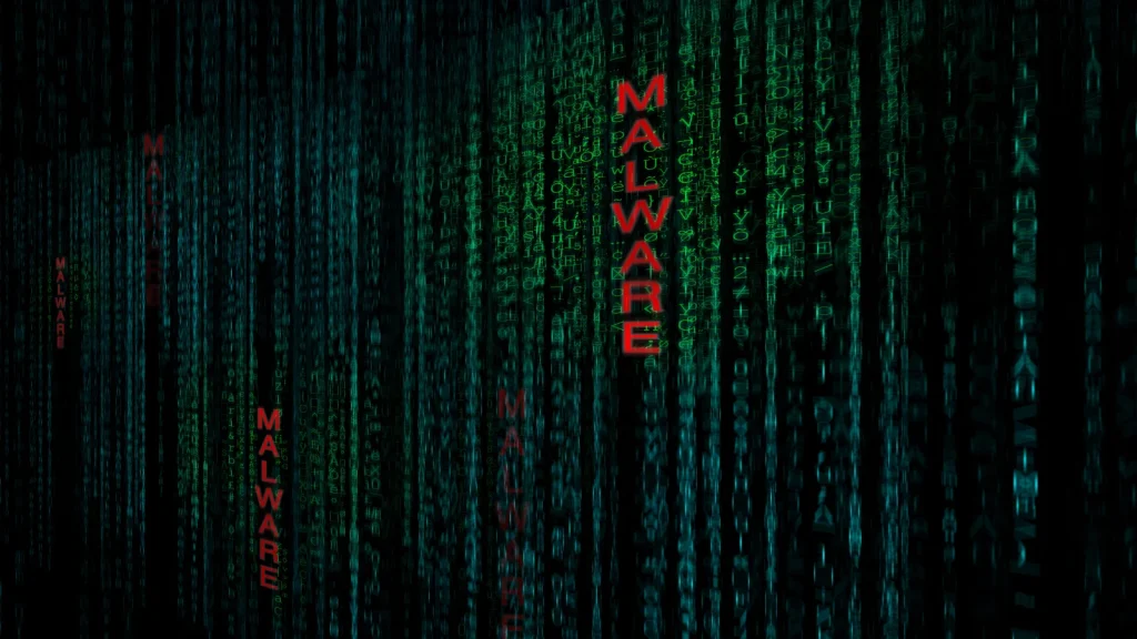 Green code streams down a dark screen, reminiscent of The Matrix, with the word MALWARE in bold red letters vertically repeated among the digital columns.