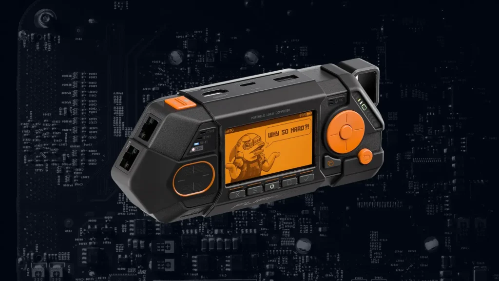A rugged black and orange portable electronic device with a screen displaying a cartoon dinosaur and the text “WHY SO HARD?!”, set against a dark background with circuit board patterns.
