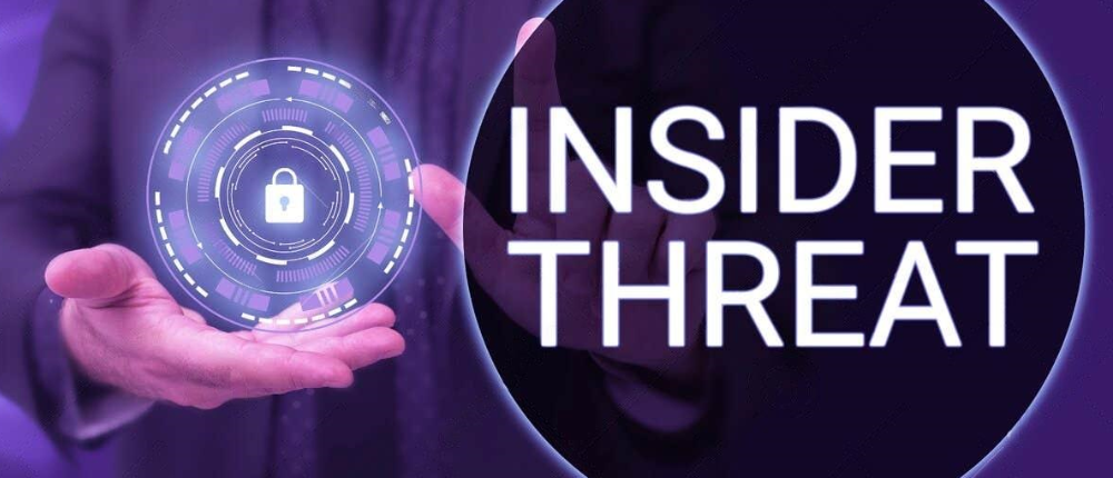 insider-threats 2 A person holds a glowing lock icon within a digital circle, next to large text that reads INSIDER THREAT on a purple background.