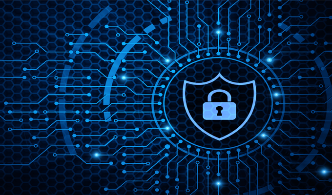 saas needs identity first PAM A digital illustration of a padlock inside a shield, surrounded by circuit lines and a hexagonal pattern, symbolizing cybersecurity and data protection on a blue background.