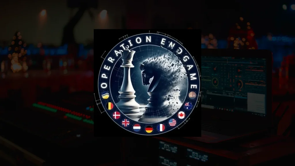 Authorities-Dismantle-SocGholish-1024×576 Logo with the text “Operation Endgame” encircling a white king chess piece and a black knight dissolving into particles, with several international flags at the bottom. Background shows blurred electronic equipment and lights.