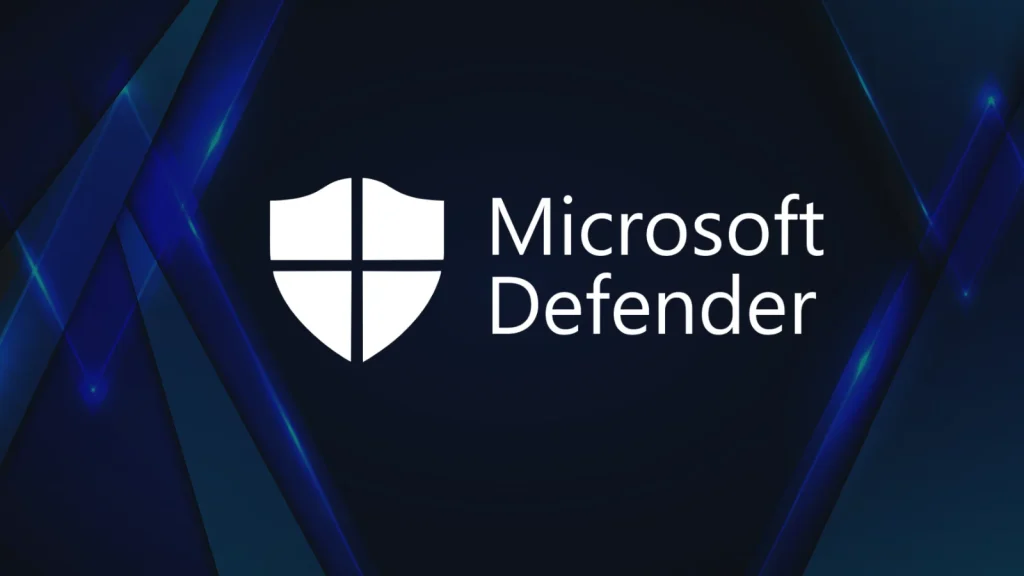 The image shows the Microsoft Defender logo, featuring a white shield icon next to the text Microsoft Defender on a dark background with blue geometric accents.