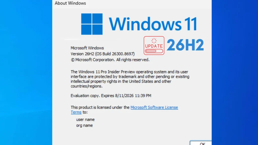 Microsoft-has-urged-IT-admins-to-prepare-for-Windows-11-version-26H2-Update-1-1024×576 Screenshot of a Windows 11 About window showing version 26H2 (OS Build 26300.869), with an Update 26H2 label, Microsoft copyright, and license info, all on a blue and white background.