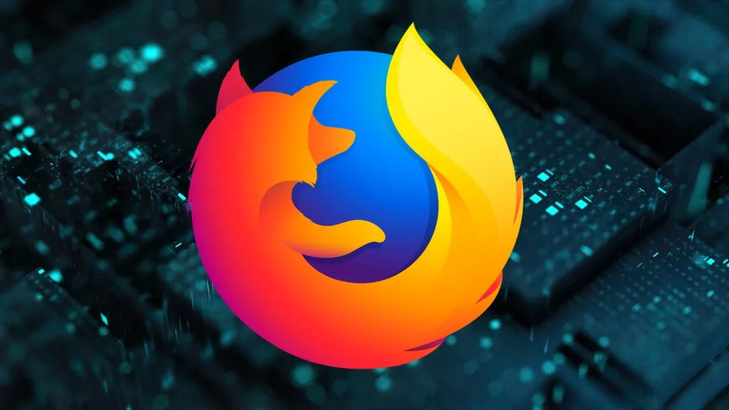 Multiple-Vulnerabilities-in-Firefox-152-Enables-Remote-Code-Execution-Attacks-1024×576 The Firefox browser logo, featuring a stylized orange fox wrapped around a blue globe, is displayed prominently against a dark, blurred background with teal highlights.