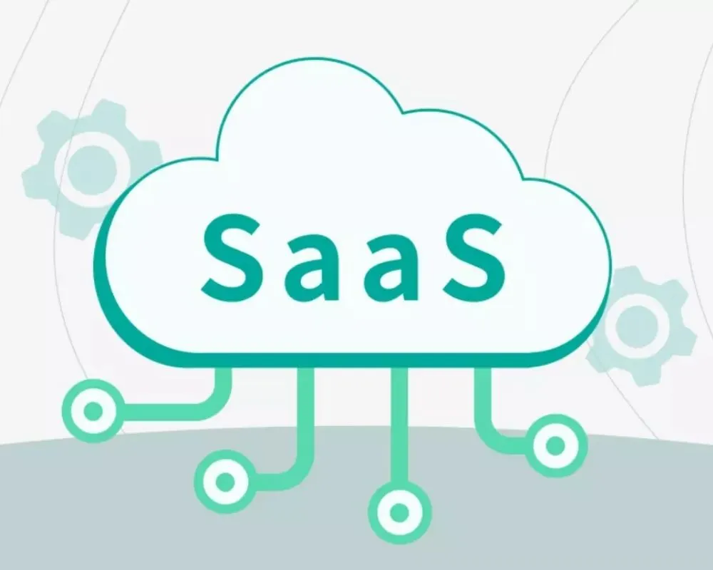 tich-hop-saas-1 Illustration of a cloud labeled SaaS with lines extending downward, resembling electronic circuits. Light gears appear in the background, representing technology and software as a service concepts.