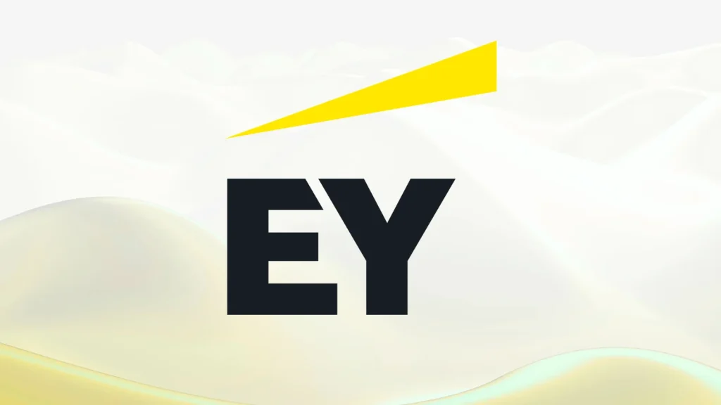EY-Data-Breach-1024×576 The image shows the EY logo, with bold black letters EY and a yellow triangle above, set against a light, abstract background.