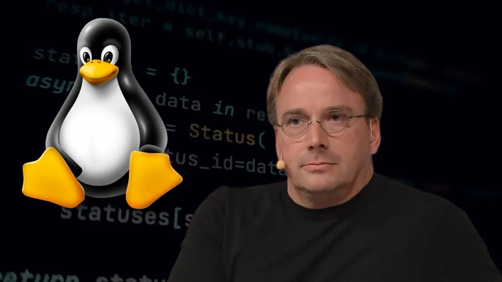 Linus-Torvalds-Linux-AI-1024×576 A man with glasses and a serious expression sits in front of code on a dark background, next to a large illustration of the Linux penguin mascot.